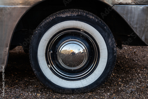 The white wall tire of a classic car that is slightly weathered in Winslow, Arizona. photo