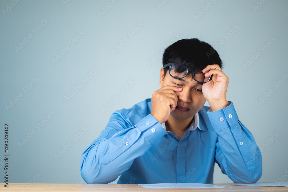 Business man pains his eyes. Then he take off his glasses. He presses on his eye by hands. Ophthalmology concept. This shot is medium close up portrait. Business man pains his eyes. Then he take off his glasses. He presses on his eye by hands. Ophthalmology concept. This shot is medium close up portrait.