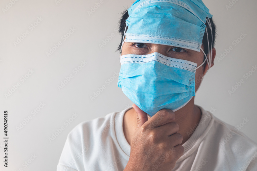 Medical masks wearing in correct way. But he uses them redundantly. Protection global pandemic of coronavirus. Other name of this disease calls COVID-19. Copy space for text.