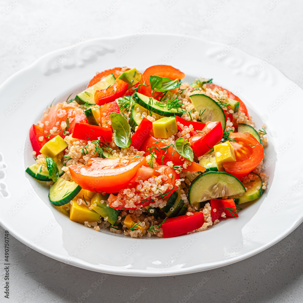 Healthy vegetable salad with quinoa and fresh herbs on a gray background. Healthy vegetable salad with quinoa and fresh herbs on a gray background.