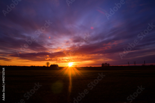 A beautiful, colorful spring sunrise over the field. Seasonal scenery of Northern Europe. © dachux21