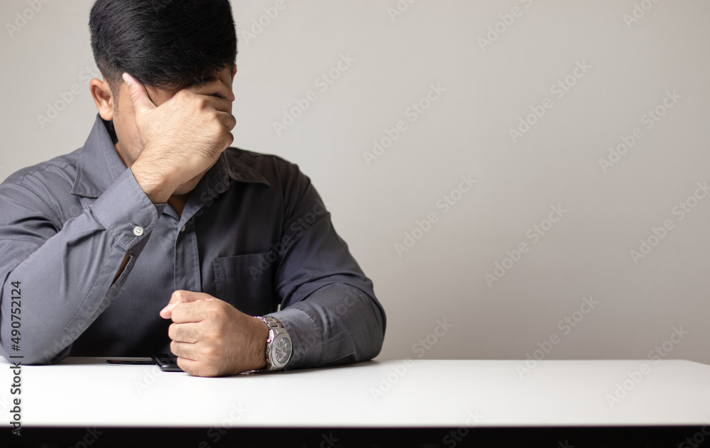 Young business man who is irritated and closes his eyes while sitting in the office at work, tired, stressed, failure. Young business man who is irritated and closes his eyes while sitting in the office at work, tired, stressed, failure.