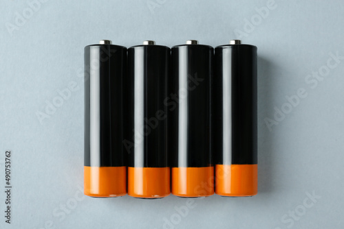 New AA batteries on light background, flat lay photo
