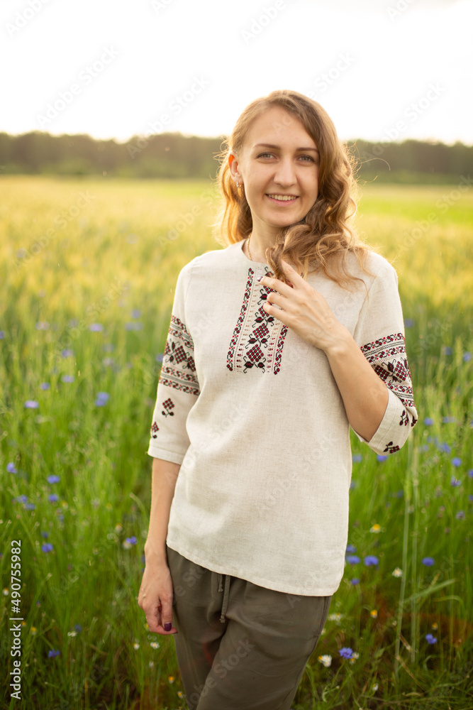 The girl is standing in the rye field. The young girl is in the green rye field. Woman is wearing Ukrainian national clothes, embroidered shirt. Smiling young lady with blue eyes, wavy blond hair.
The girl is standing in the rye field. The young girl is in the green rye field. Woman is wearing Ukrainian national clothes, embroidered shirt. Smiling young lady with blue eyes, wavy blond hair.