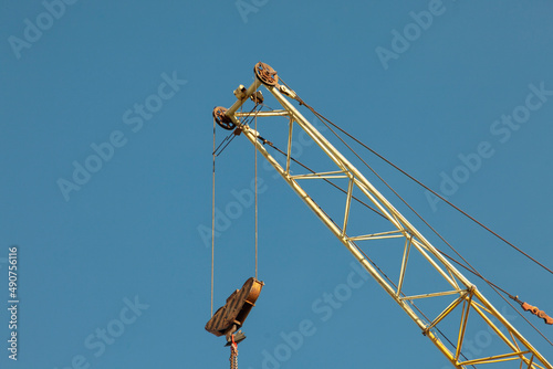 Crane. Heavy machinery. Hook for cargo. Arrow to hold cable.