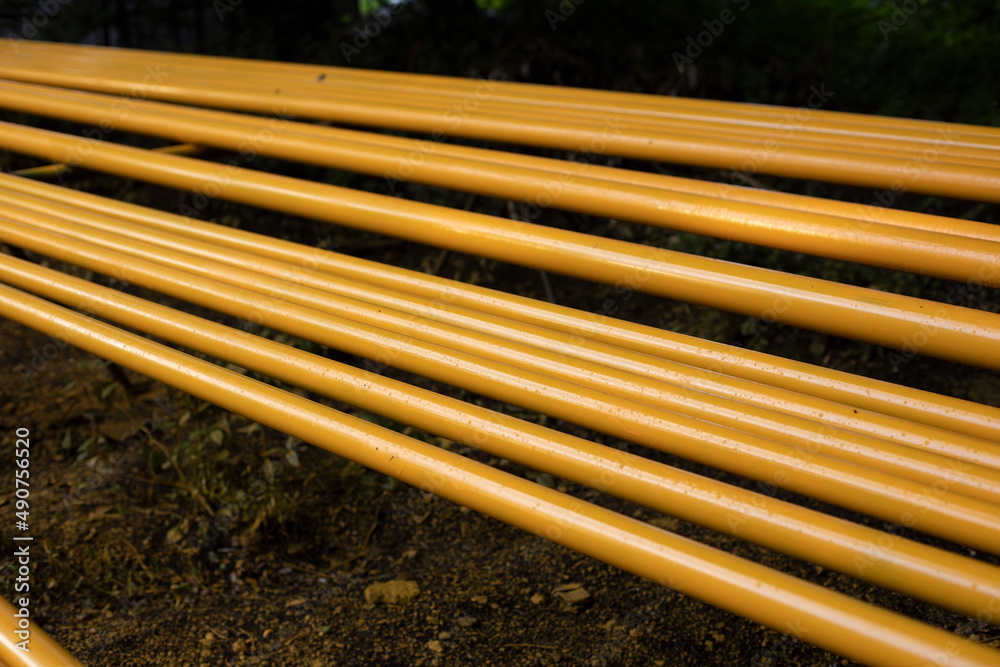Yellow pipes. Gas pipes lie in row. Preparation of equipment replacement. Yellow pipes. Gas pipes lie in row. Preparation of equipment replacement.