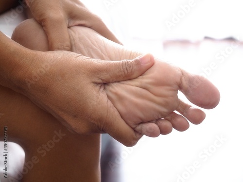 foot injury use hand massage on feet to relax muscle from heel pain, ankles and bones from inflammation of tendons.