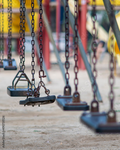 Closeup of swings in a children play area at park