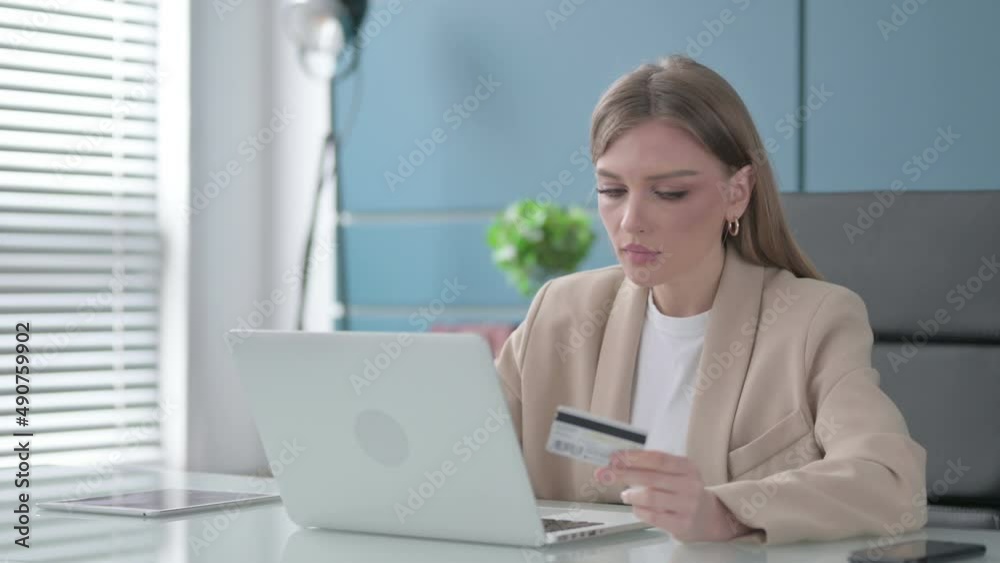 Businesswoman Shopping Online on Laptop at Work