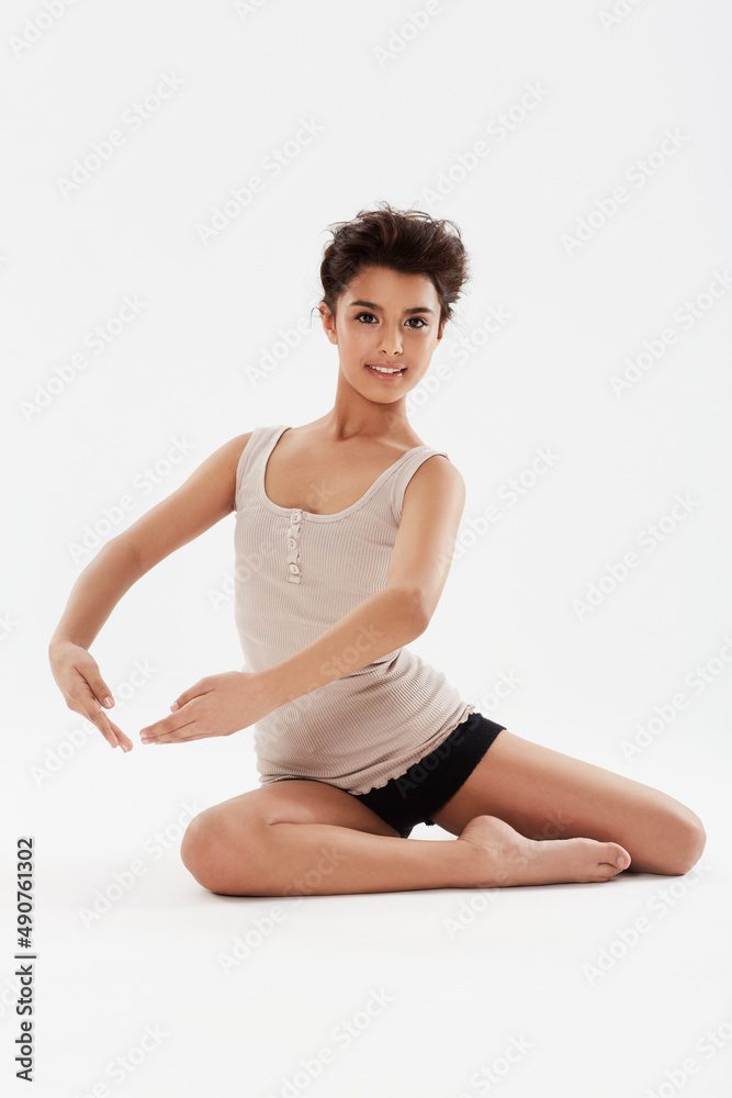 Dancing is her passion and she strives to be the best. A cute teenage dancer posing in studio with a big smile on her face. Dancing is her passion and she strives to be the best. A cute teenage dancer posing in studio with a big smile on her face.