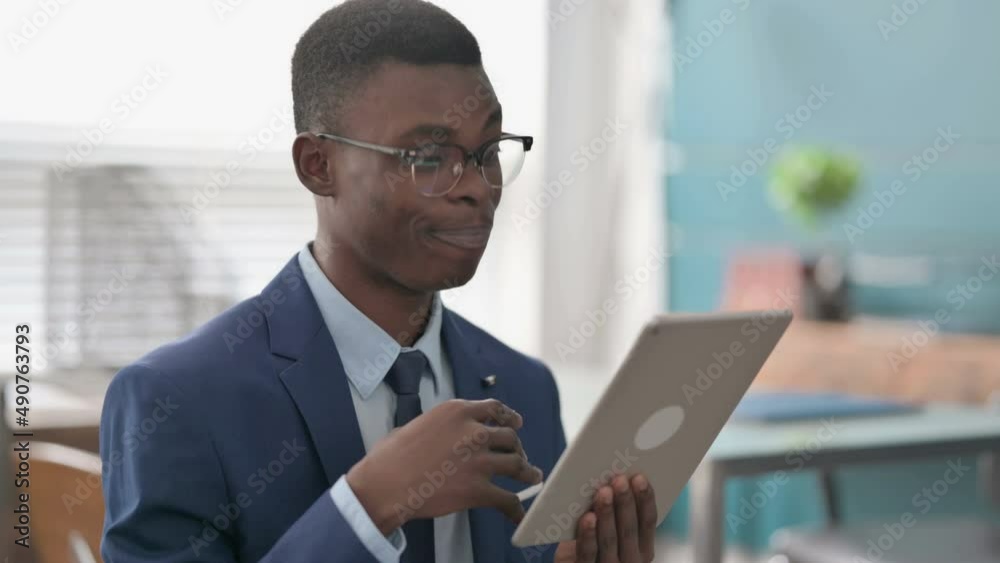 Video Call on Tablet by Young African Businessman in Office 