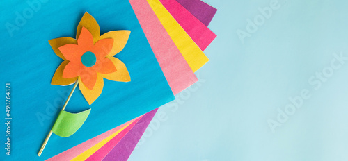 Handmade flowers from multi-colored paper for mother's day, women's day on March 8, birthday. Banner. Creativity and leisure of the child. Flower for craft or postcard. DIY. space for text