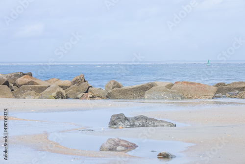 Rocks on the beach, ocean and sky background