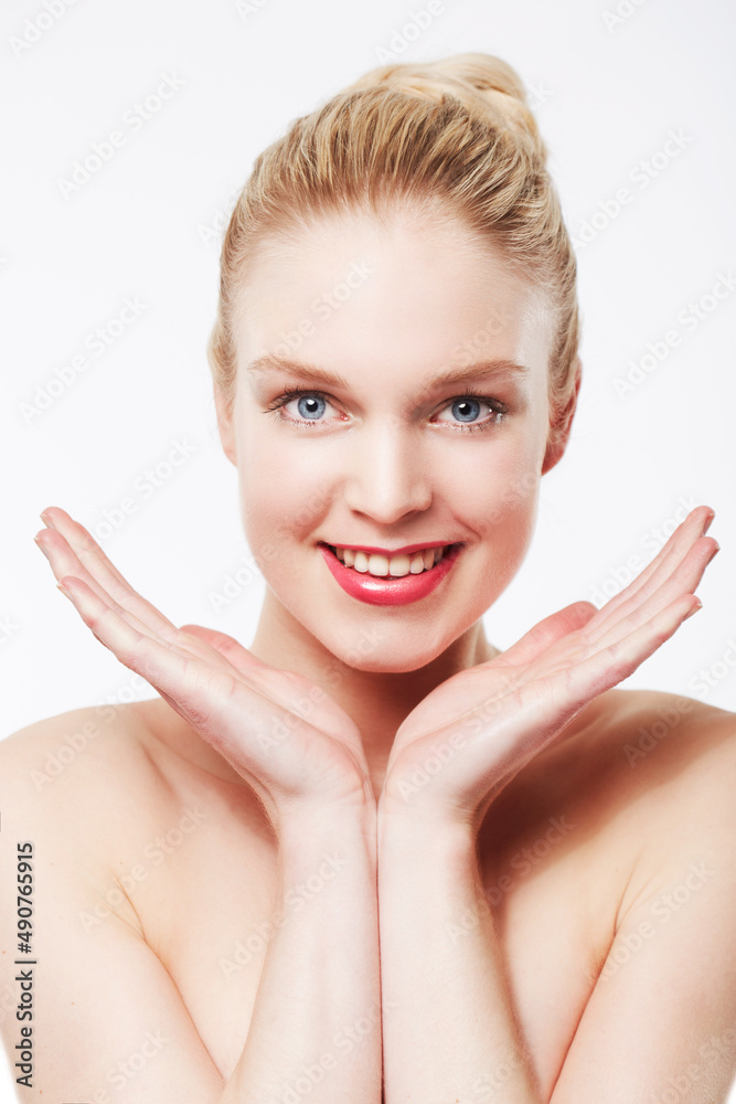 Ive found the secret to perfect skin. Portrait of a smiling blonde caucasian woman with her hands framing her face.