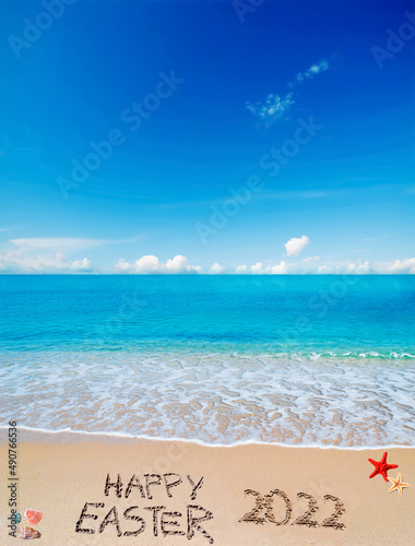 happy easter 2022 on a tropical beach under clouds