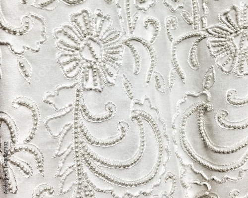 Close-up detail of white and ivory beaded wedding gown