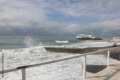 Sochi, Russia 05.07.2021. Breakwater pier summer black sea cloudy. photo