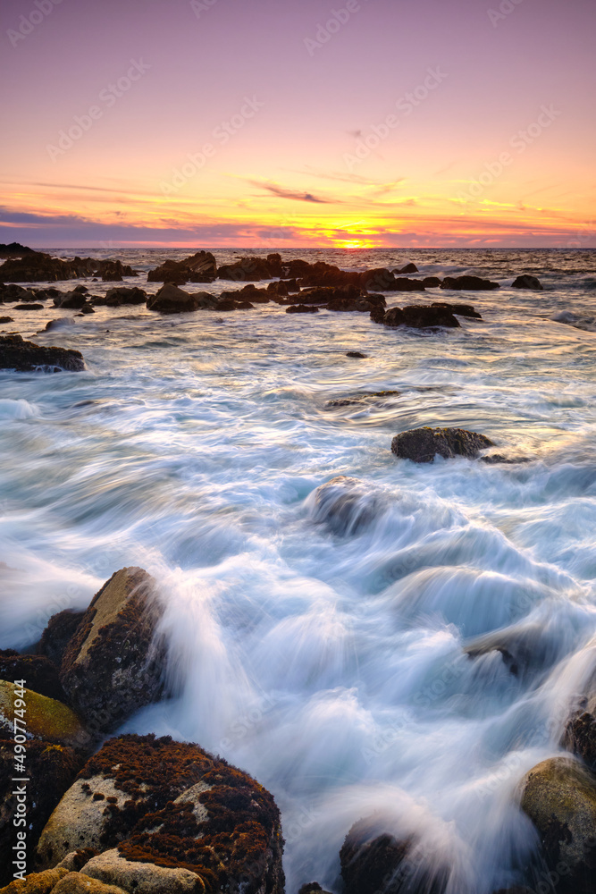 Sunset on the rocky shore of Pacific Grove overlooking Monterey Bay.