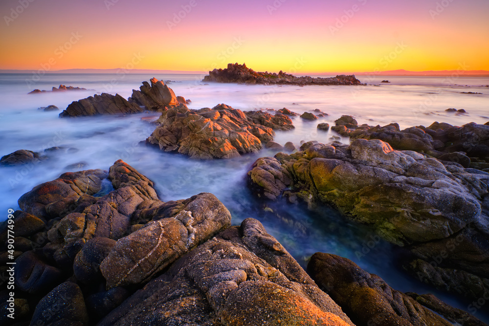 Sunrise over the rocky coastline of Pacific Grove overlooking Monterey Bay. 