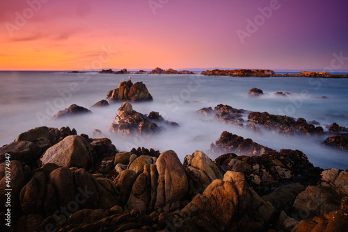 Sunset on the rocky shore of Pacific Grove overlooking Monterey Bay. © Greg Larson