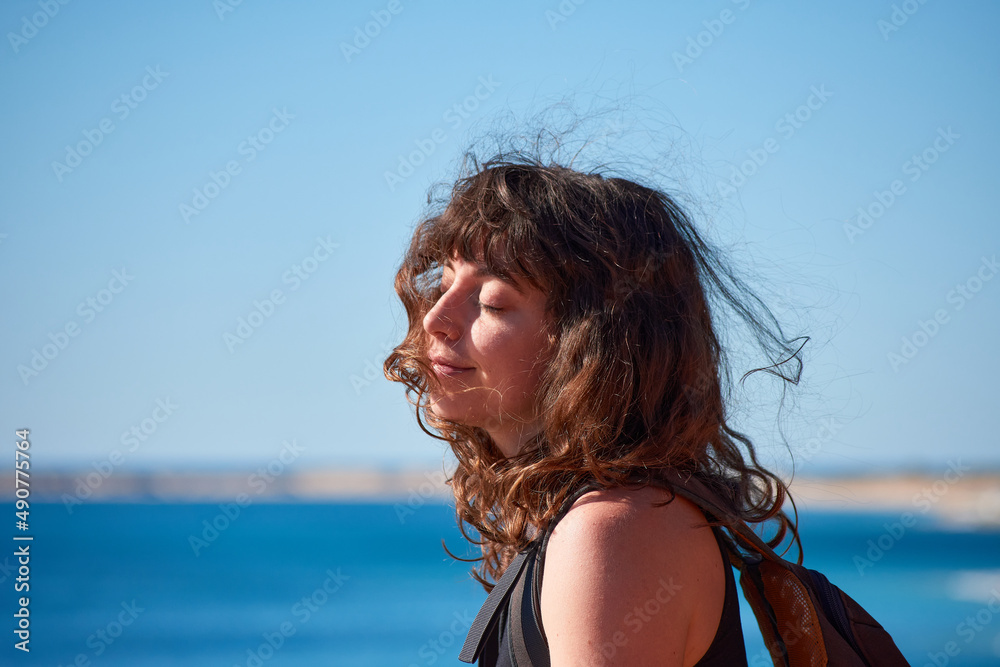 Naklejka premium A portrait of a young Caucasian girl on the beach in Spain