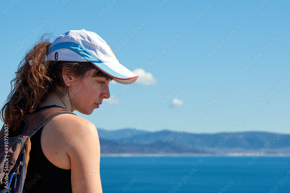 A closeup of a woman from behind looking at the sea A closeup of a woman from behind looking at the sea