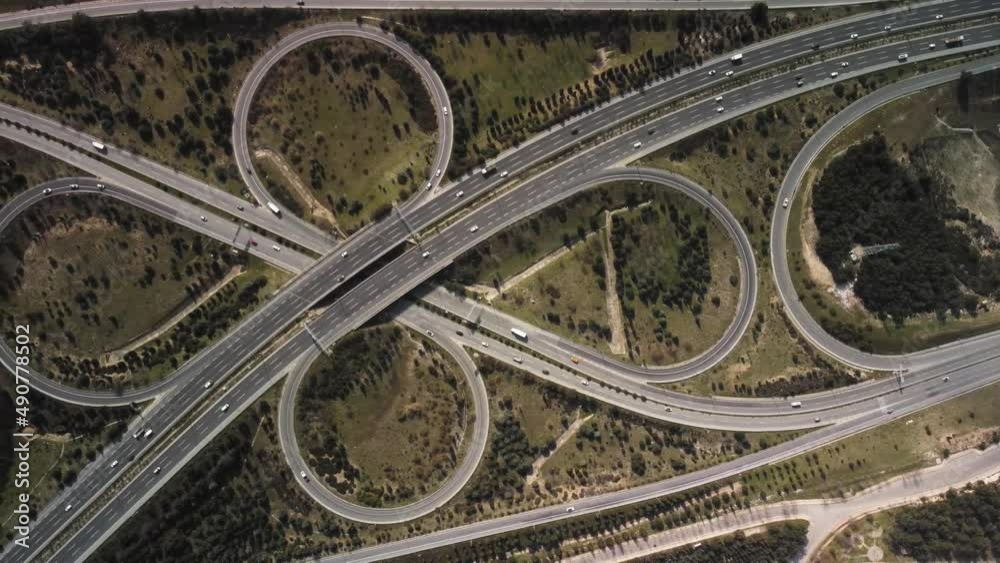 Aerial view of highway junctions with roundabout. Bridge roads shape circle in structure of architecture and transportation concept. Top view. Izmir Turkey. High quality 4k footage