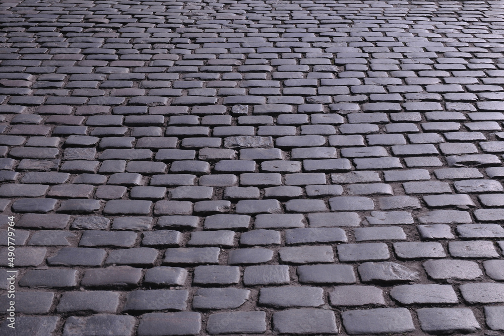 Old stone pavements in the streets of European cities ...