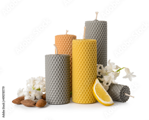 Composition with wax candles and flowers on white background photo