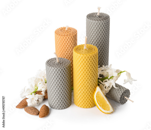 Composition with wax candles and flowers on white background photo