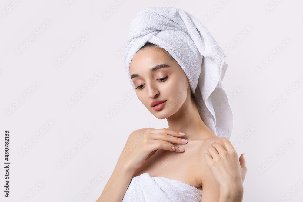 Beautiful girl with thick eyebrows and perfect skin at white background, towel on head, beauty photo. Beautiful girl with thick eyebrows and perfect skin at white background, towel on head, beauty photo.