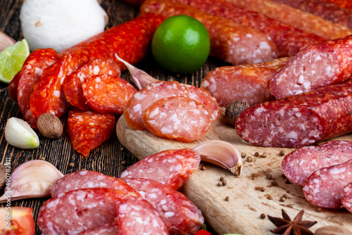 sliced pieces of sausage from meat are lying on a cutting board