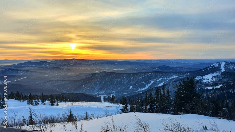 Sunset in the mountains in winter. Fantastic evening winter landscape. Dramatic overcast sky. Creative college. The world of beauty. Sunset in the mountains in winter. Fantastic evening winter landscape. Dramatic overcast sky. Creative college. The world of beauty.