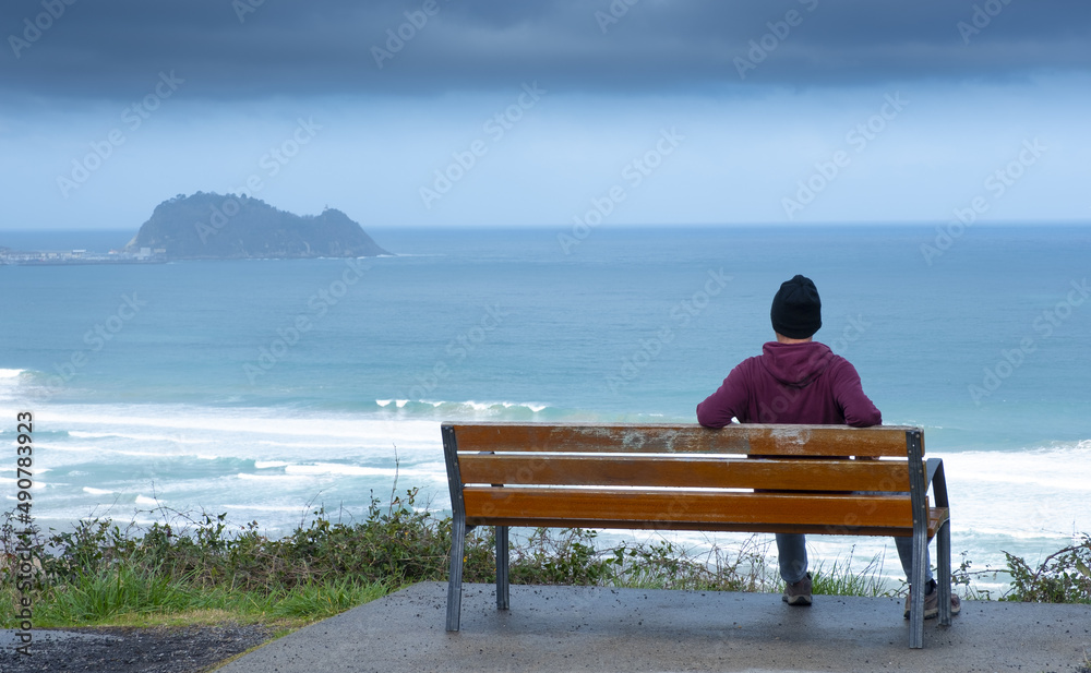 Man contemplating the sea in front of Getaria, Euskadi