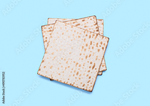 Jewish flatbread matza for Passover on blue background