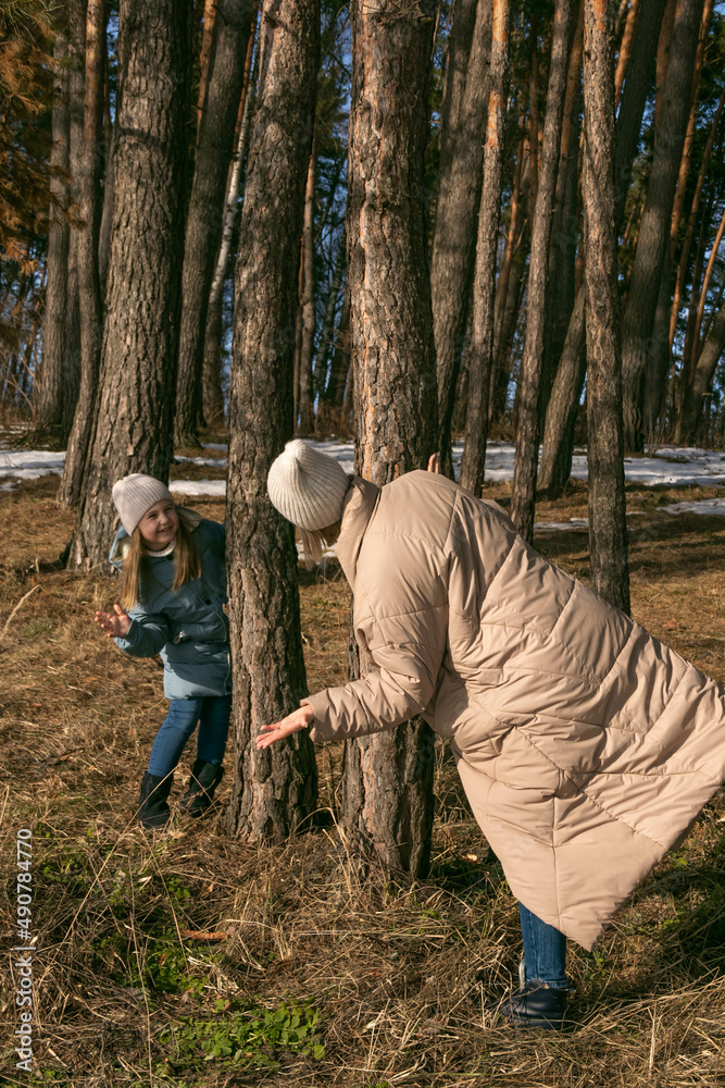 mom and daughter walk in the spring forest mom and daughter walk in the spring forest