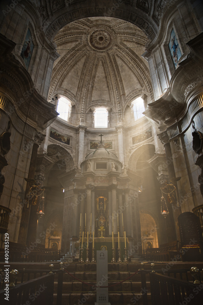 interior of the cathedral of Cadiz with sunbeams entering through the windows