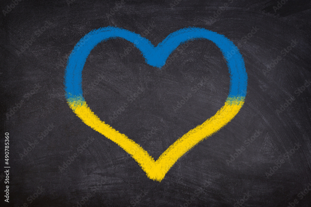 Heart shape chalk drawing on blackboard in Ukrainian Flag colors: blue and yellow. Heart shape chalk drawing on blackboard in Ukrainian Flag colors: blue and yellow.