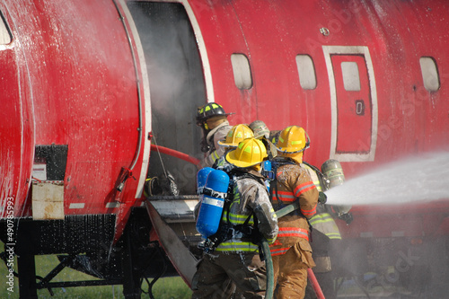 Firefighters training for airplane fire photo