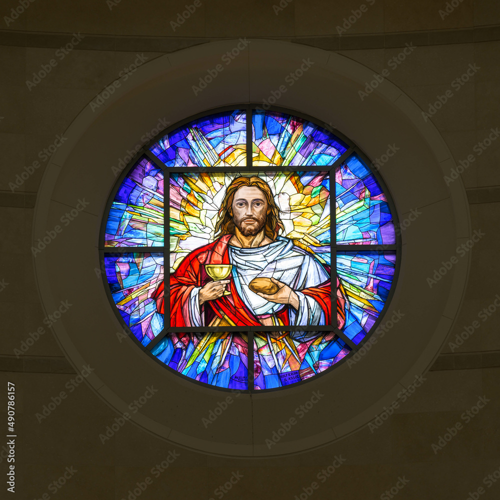 Round stained glass window of Jesus Christ in the CoCathedral of the
