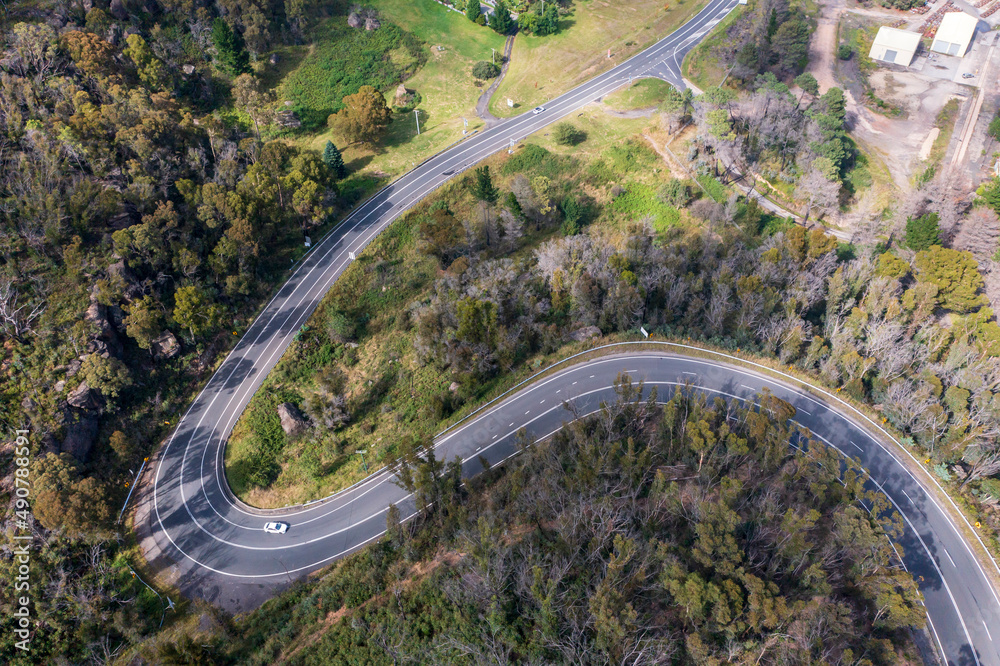 Drone aerial photograph of a highway running through a forest in regional Australia.