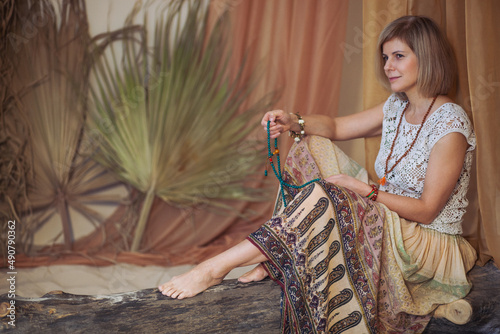 The concept of zen, peace, balance. A woman sits and meditates  using Mudra, keeping her legs crossed