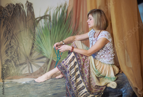 The concept of zen, peace, balance. A woman sits and meditates  using Mudra, keeping her legs crossed