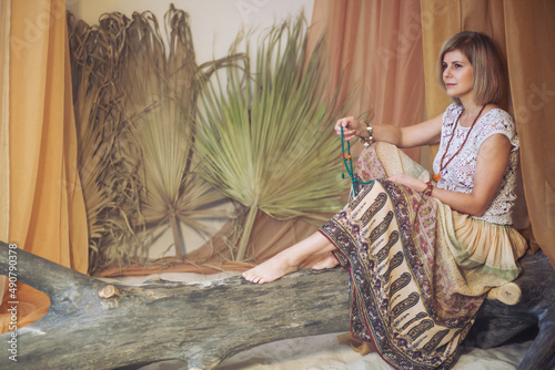 The concept of zen, peace, balance. A woman sits and meditates  using Mudra, keeping her legs crossed