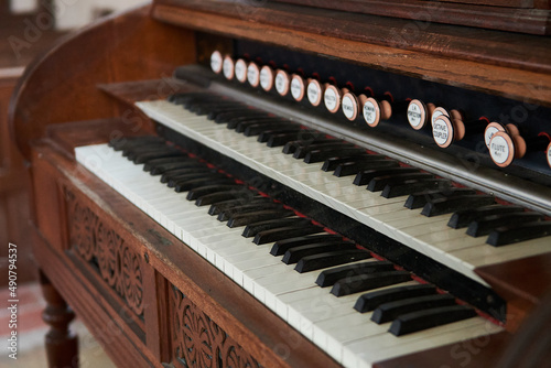 Old wooden harmonium inside a church photo