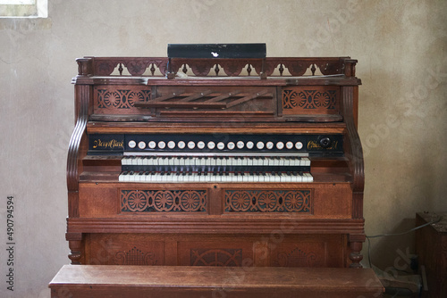 Old wooden harmonium inside a church photo