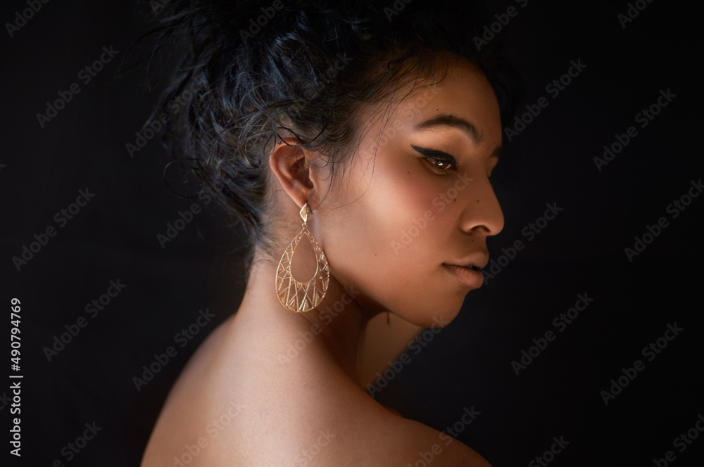 Never ask a girl with winged eyeliner why shes late. Cropped shot of a beautiful young woman against a dark background. Never ask a girl with winged eyeliner why shes late. Cropped shot of a beautiful young woman against a dark background.