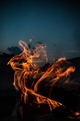 Vertical shot of burning fire on dark background