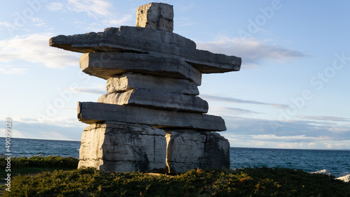 Inukshuk sculpture with large stacked and balanced rocks photo