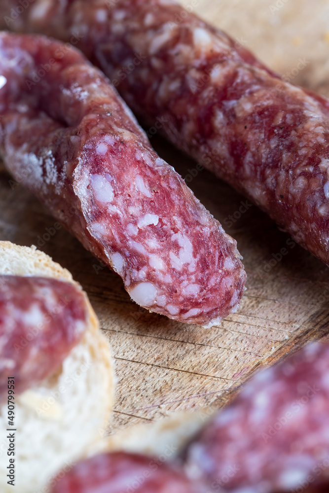 sliced pieces of sausage from meat are lying on a cutting board sliced pieces of sausage from meat are lying on a cutting board